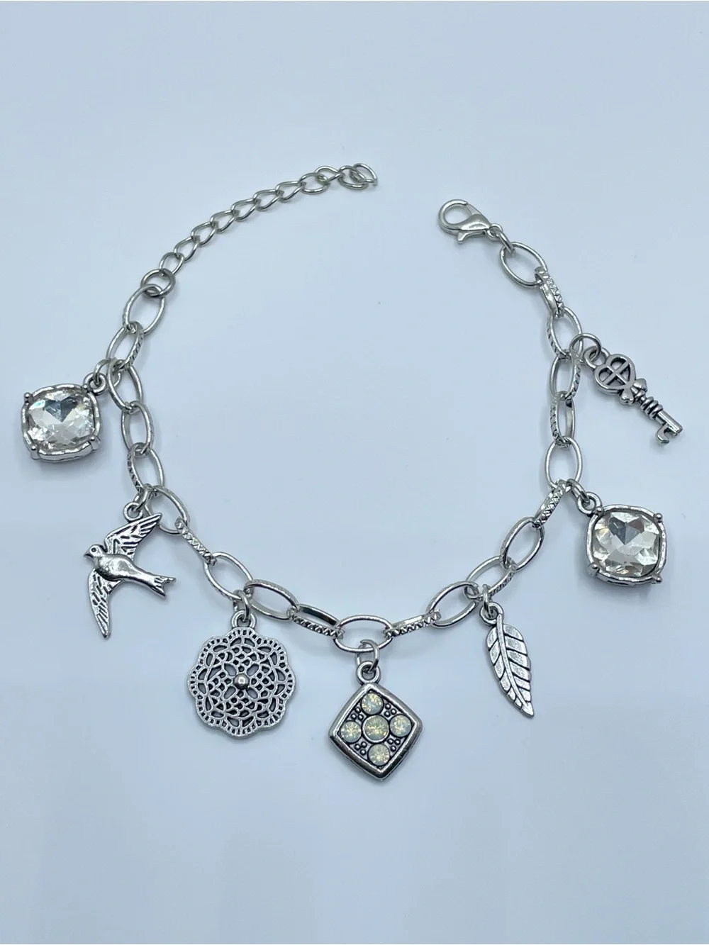 Silver Tone Crystal Charm Bracelet Bird Key Leaf Dangle Statement